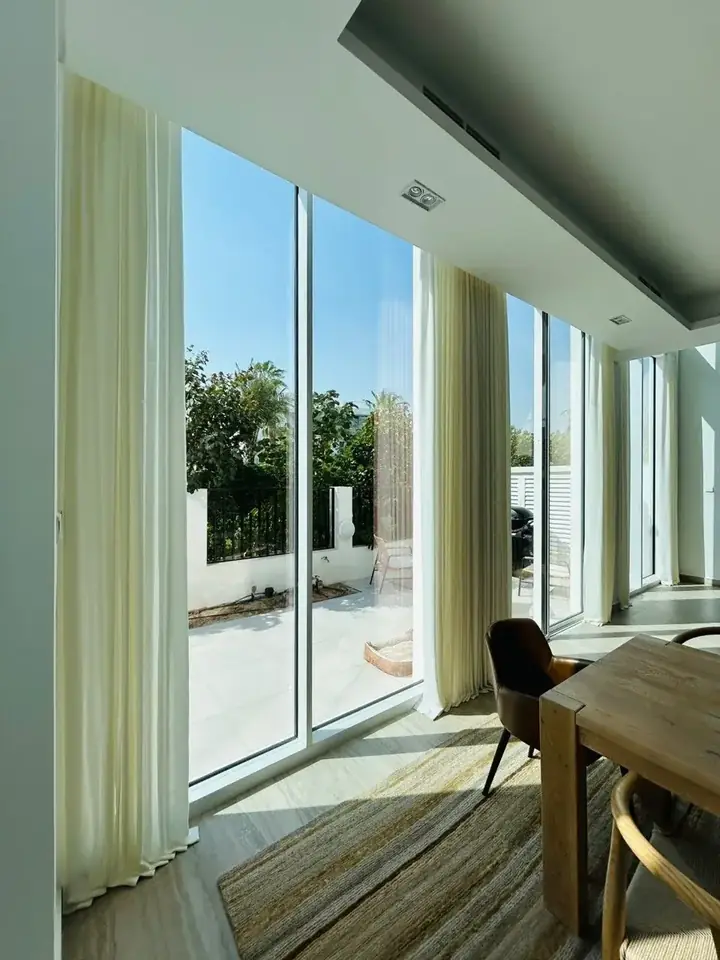 Sun-filled terrace with sheer curtains